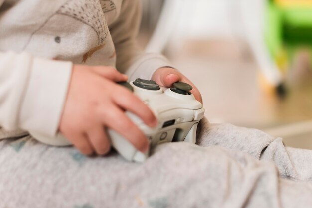 Close-up kid holding controller