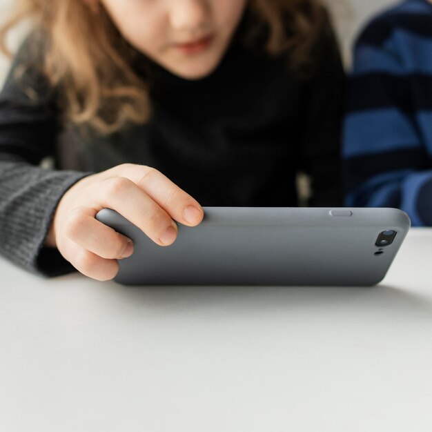 Close-up kid holding phone