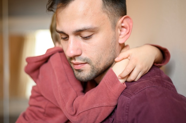 Close-up kid hugging father