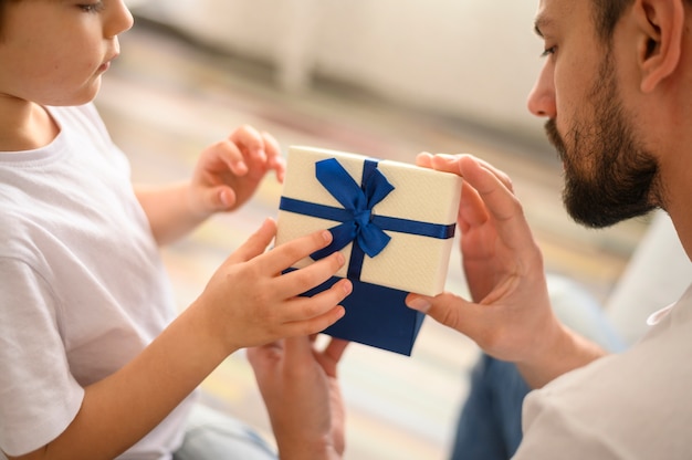 Close-up kid offering present