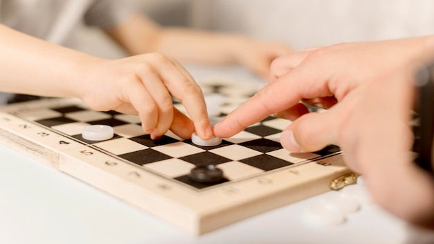 Foto gratuita bambino del primo piano che gioca scacchi