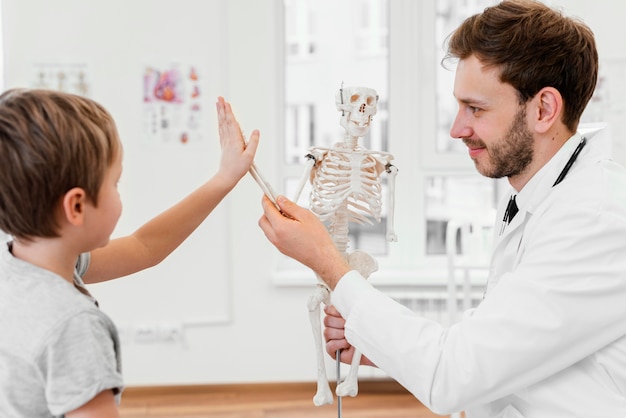 Close-up kid playing with skeleton