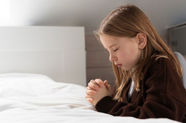 Close up on kid praying