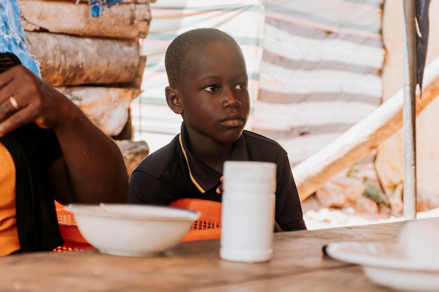 Close-up kid sitting at table