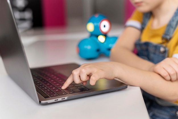 Close up kid typing on keyboard