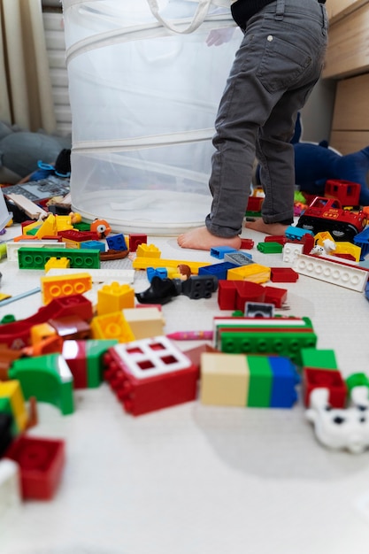 Close up kid with toys on floor