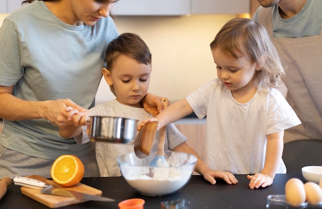 Close-up kids cooking with parents