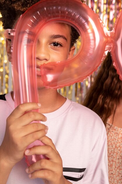 Free photo close up kids holding balloons