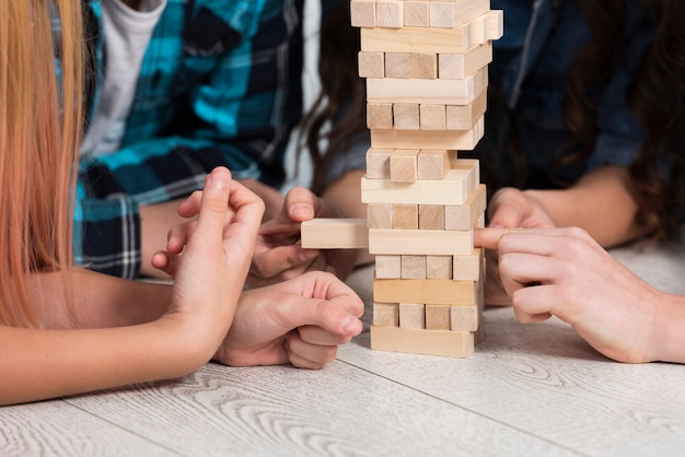 Close-up kids playing jenga