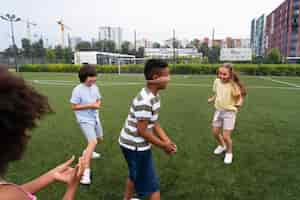 Free photo close up kids playing tag game