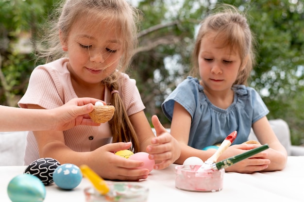 Close up kids with painted eggs