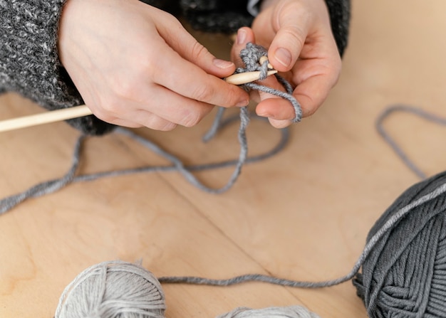 Close-up knitter creating at home