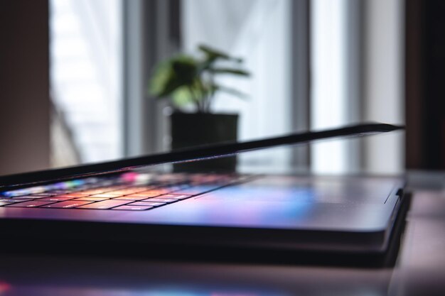 Close up of laptop keyboard colorful neon illumination backlit keyboard