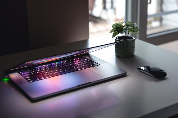 Free photo close up of laptop keyboard colorful neon illumination backlit keyboard