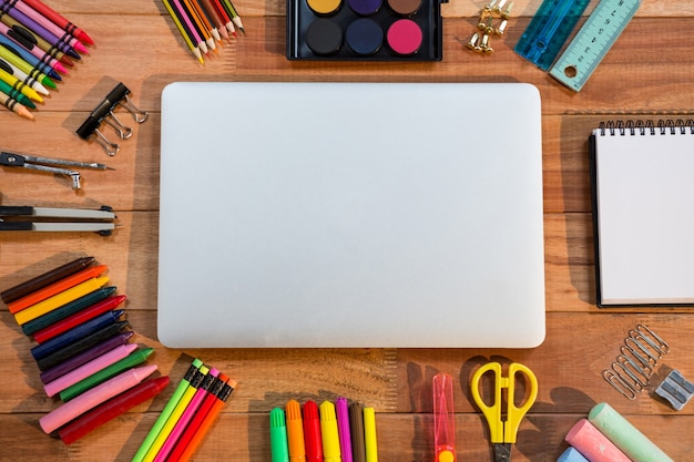 Close-up of laptop with various stationery