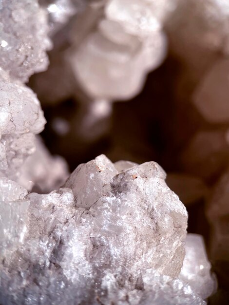 A close up of a large white quartz rock with a small black speck on the top.