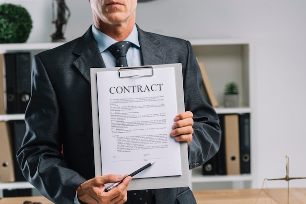 Free photo close-up of lawyer showing legal contract agreement with pen