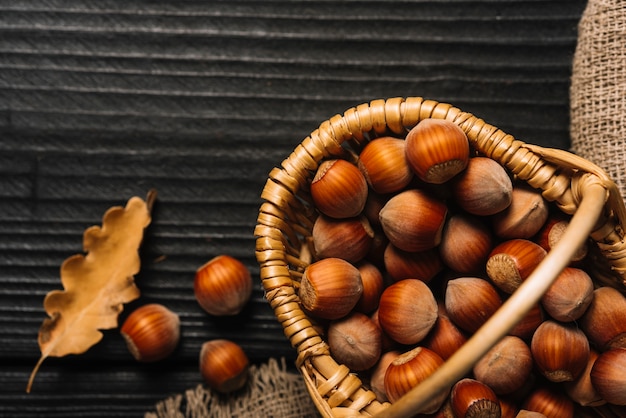 Free photo close-up leaf near basket with nuts