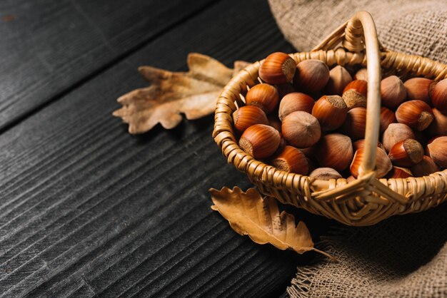 Close-up leaves and hazelnuts near fabric