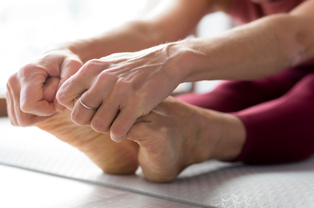 Close-up legs and hands doing stretching exercises