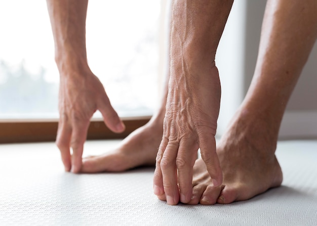 Free photo close-up legs and hands of a senior man