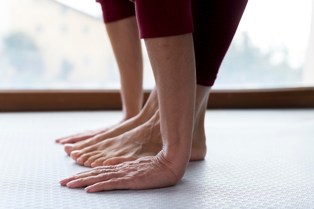 Close-up legs and hands of a senior woman