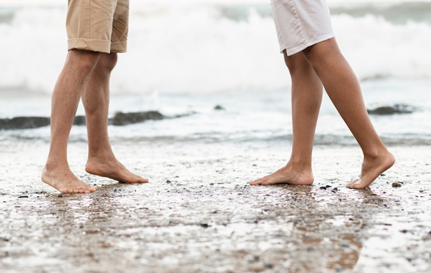 Close-up legs standing on shore