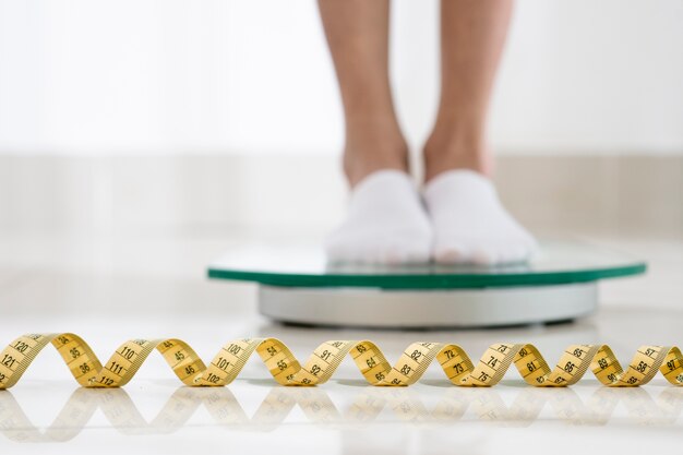 Close up legs on weight machine