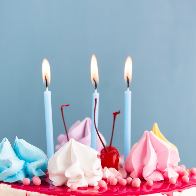 Close-up of lit candles on cake
