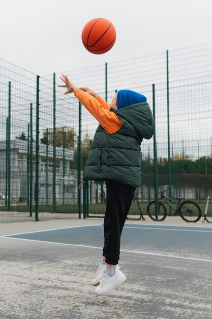 Close up on little boy playing basketball