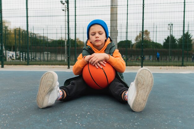 Close up on little boy playing basketball