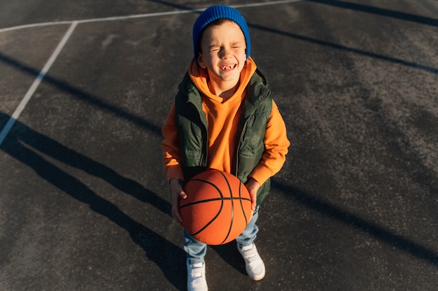 Close up on little boy playing basketball