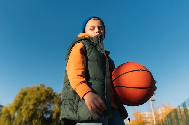 Close up on little boy playing basketball