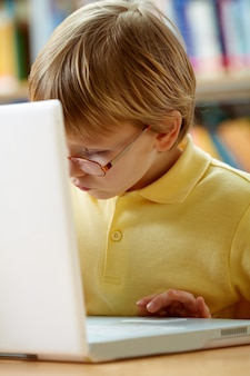 Close-up of little boy with laptop