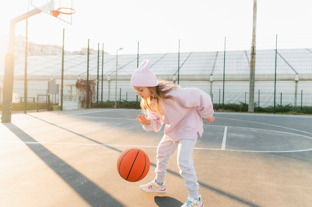 Close up on little girl playing basketball