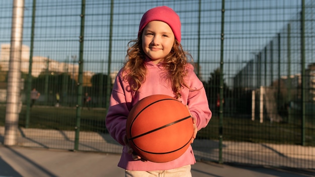 Close up on little girl playing basketball