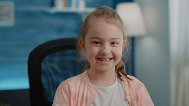 Close up of little girl sitting at desk and preparing to do homework