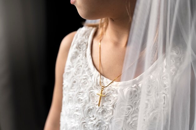 Close up little girl wearing crucifix