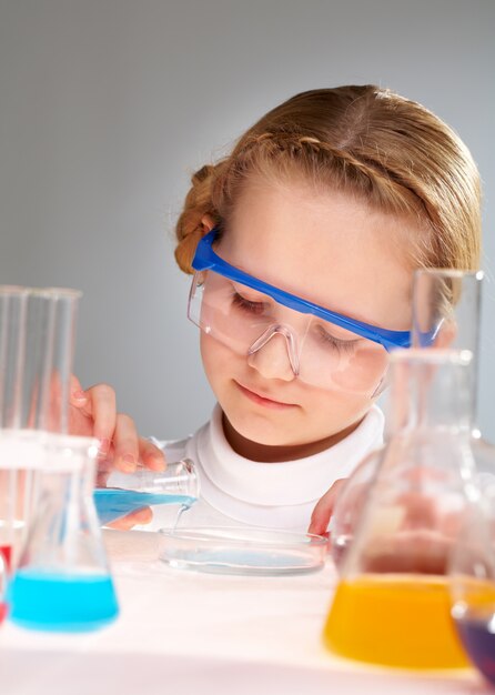 Close-up of little girl with flasks