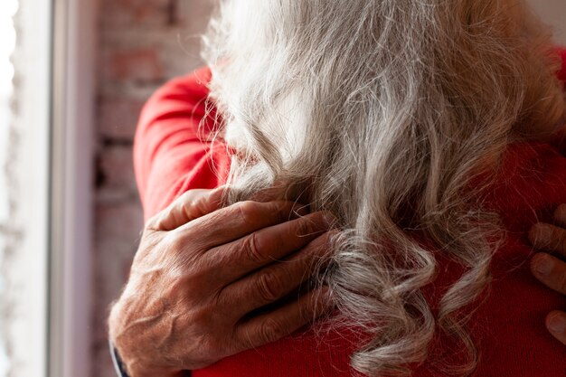 Close-up lovely senior couple hugging