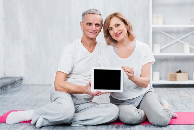 Close-up of a loving couple holding black screen digital tablet