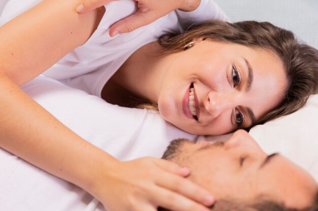 Close-up loving couple relaxing on bed