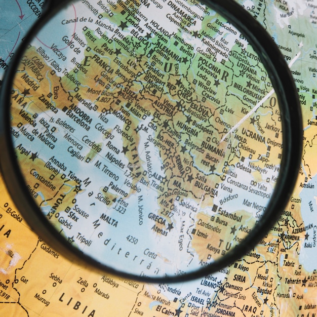 Close-up magnifying glass over globe