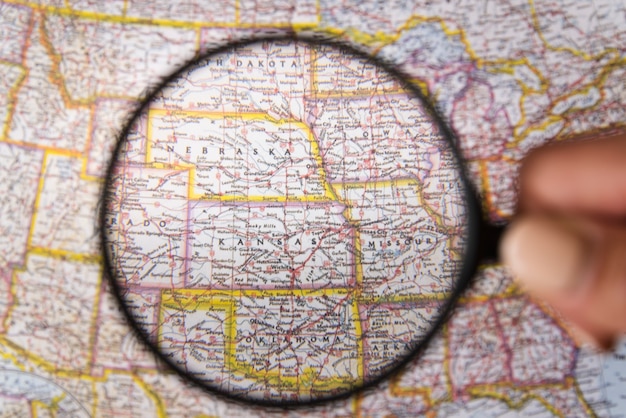 Close up magnifying glass showing places on map