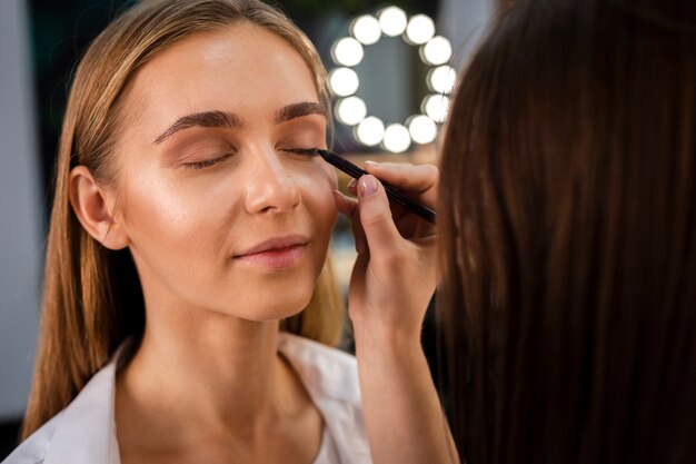 Close-up make-up artist applying eyeshadow