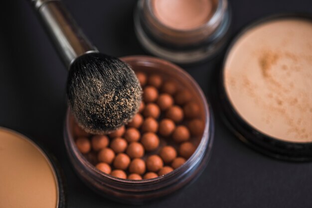 Close-up of makeup brush on bronzing pearls