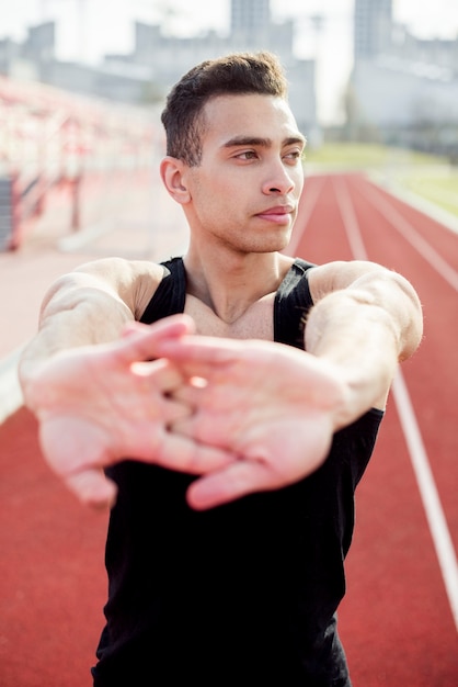 close-up of a male athlete warming before running on running track