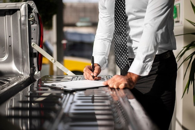 Close-up male checking clipboard list