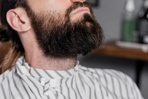 Close-up of a male customer's beard in barber shop