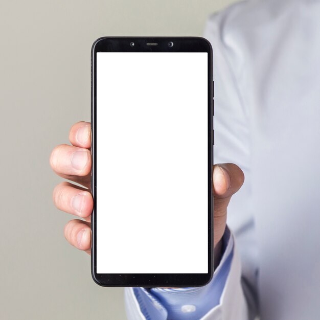 Close-up of male doctor's hand showing smartphone with white screen display